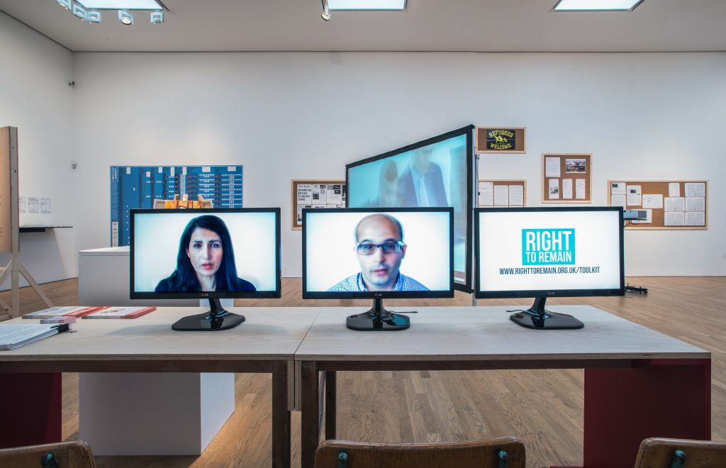 Image of a table with several screens showing people's faces