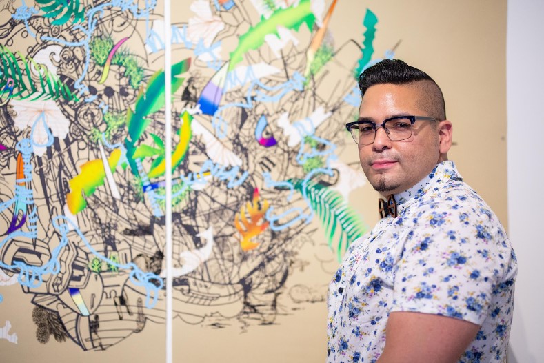 David Rios in front of a graphic print.