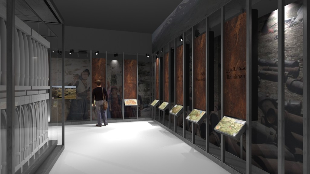 A visitor looks at a display of photos of Kurdish people.