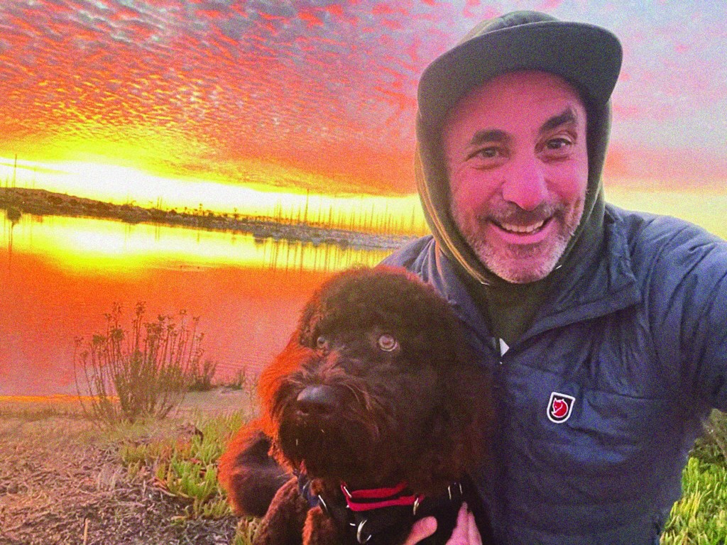 The author and his dog, Blue, celebrating a particularly spectacular golden hour on an early morning walk near their home. Photo credit: Micah Parzen
