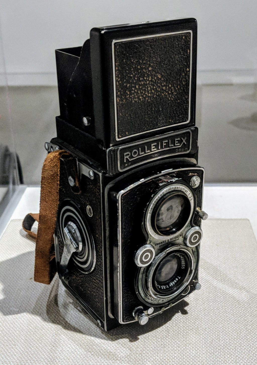 An antique camera on display in a museum.