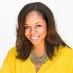 Headshot of Janeen Bryant, a black woman with long dark brown hair wearing a bright yellow top. 