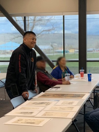 Above: Jewie Davis and other Colville community members near reproductions of portraits Clyfford Still made of their relatives. Lucy F. Covington Government Center, Nespelem, WA, April 2022. Photo credit: Bailey Placzek.