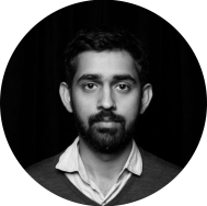 photo of a young bearded man, Surya Mattu, in black and white. He's look straight at the camera with no expression.