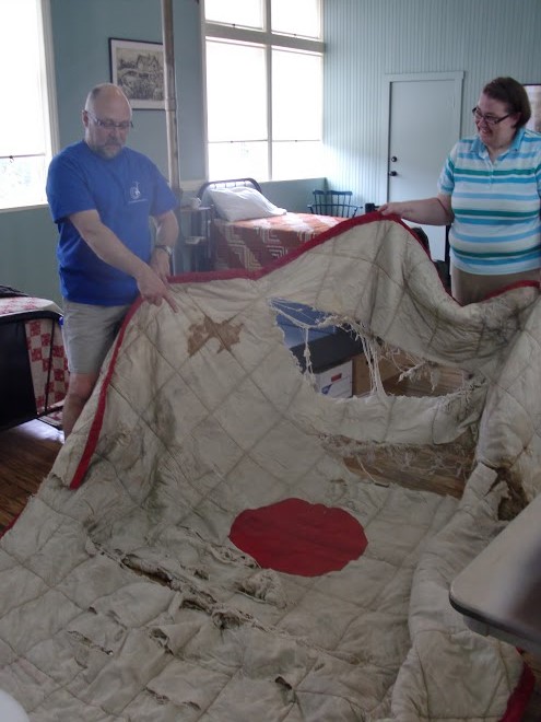 Libby Krecek and Roger Machin examine a firefighter’s life net from the collections of the Houston Fire Museum