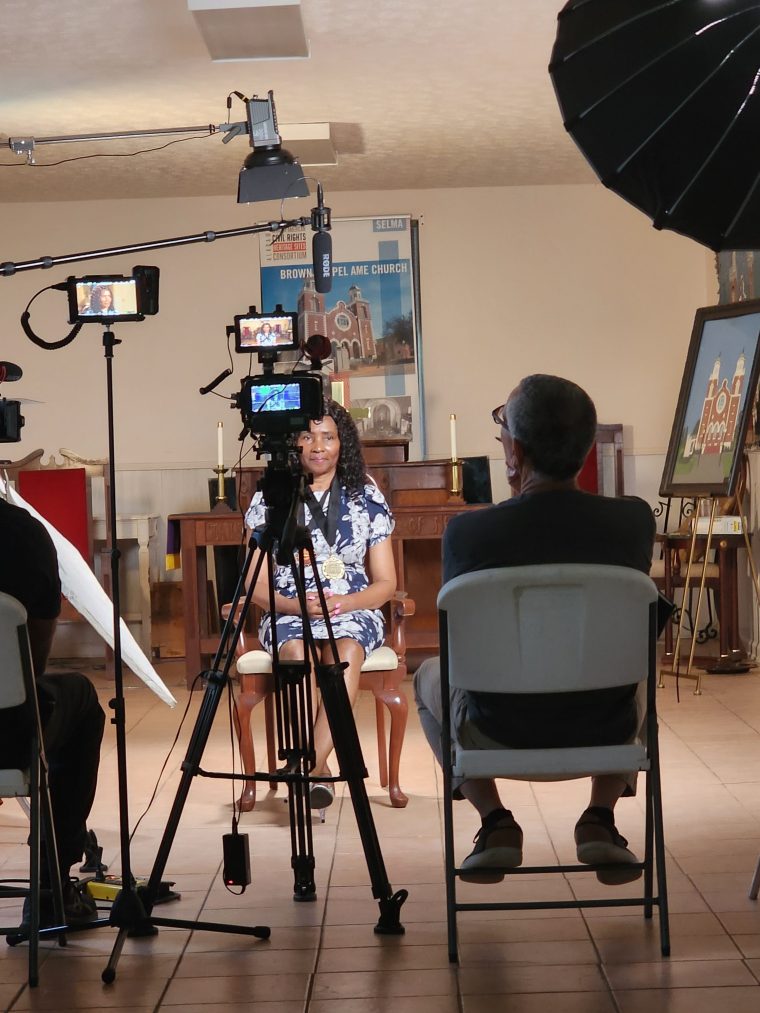 A subject speaking to a camera crew