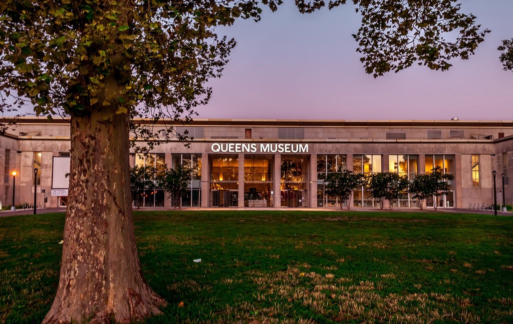 Facade of Queens Museum with great lawn space visible