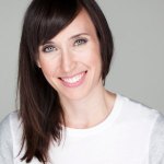 Image of woman's face with shoulder length dark brown hair