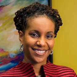 Headshot of Dr. Tonya Matthews, a black woman with short curly black hair wearing a striped black and red jacket.
