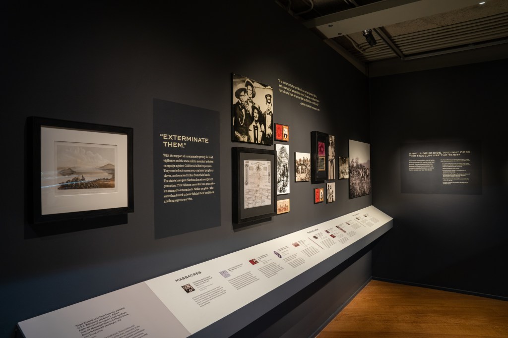A historical timeline is seen, with framed photos and documents illustrating the history described. The title "Exterminate Them" is visible.