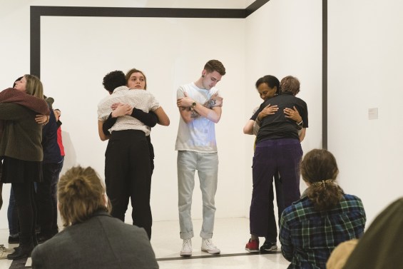 Several groups of two people hug in the blank white space.