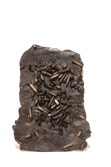 What looks like a copper statue with bullet casings enclosed in the bronze.
