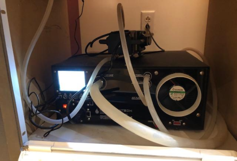 A small mechanical system with tubes leading to the case
