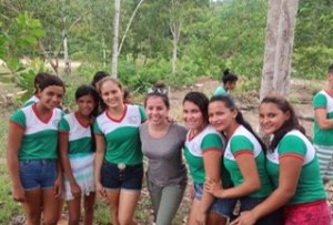 A group of 7 women crowd together for the picture