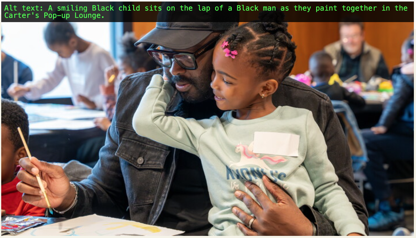 A smiling Black child sits on the lap of a Black man as they paint together in the Carter's Pop-up Lounge.
