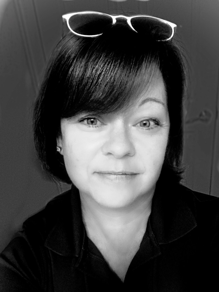 Photo of Amy Bartow-Melia. She is wearing a black shirt and has short brown hair.