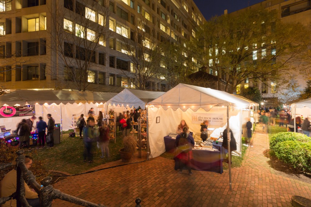 Heurich House's popular Christmas Market in the courtyard at night.