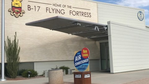 Exterior of the 390th museum with a sign reading now air conditioned for your comfort and new exhibits