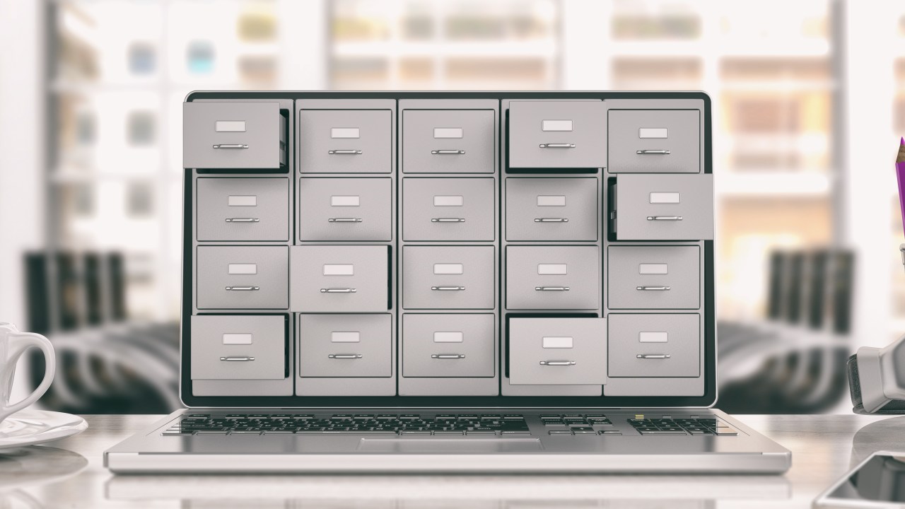 A laptop showing a set of filing cabinets on its screen