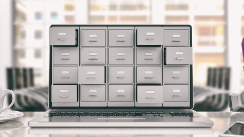 A laptop showing a set of filing cabinets on its screen