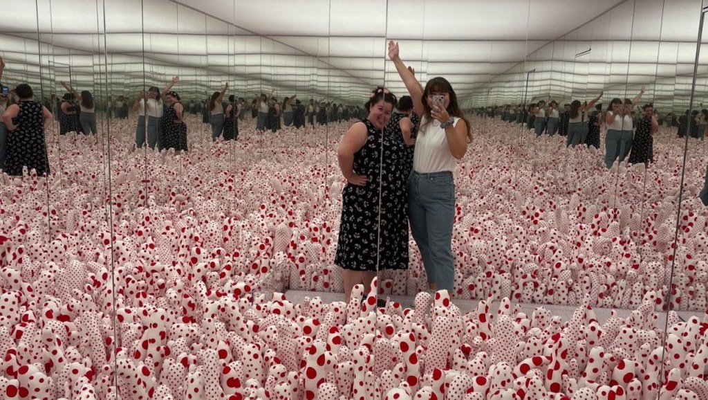 Two young people taking a selfie in an immersive art installation