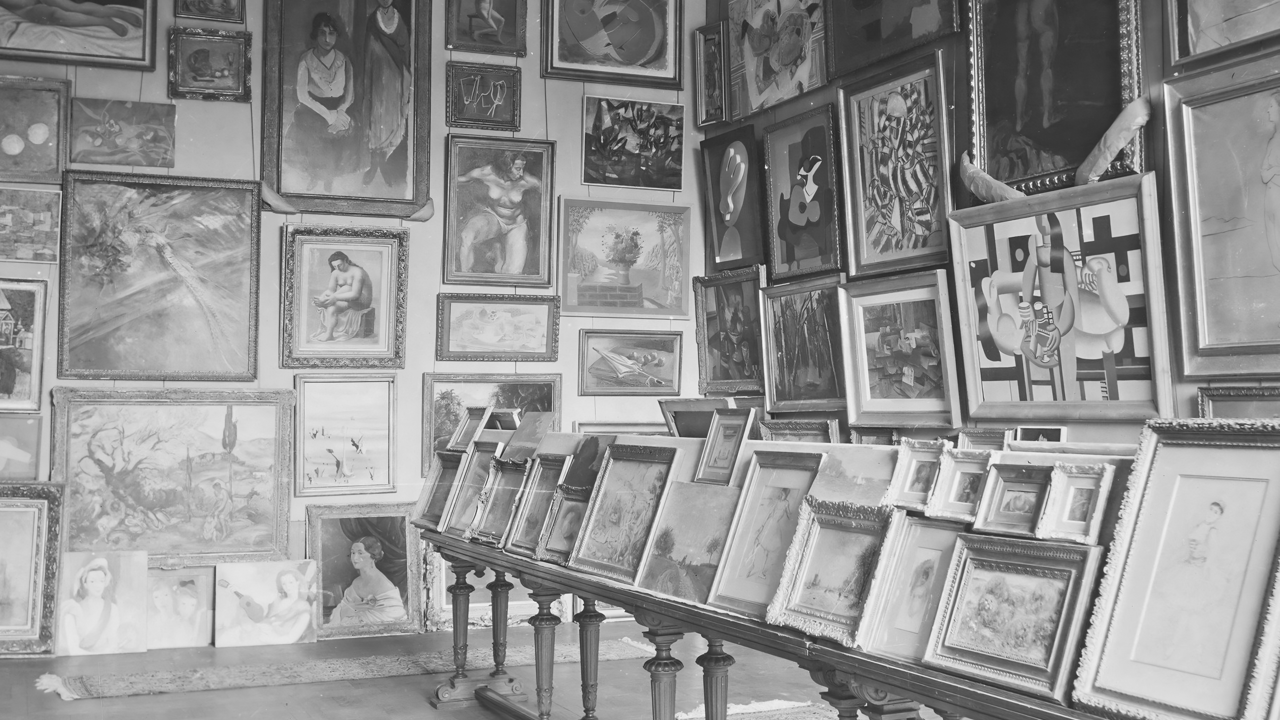 A black and white photograph with a multitude of artwork.