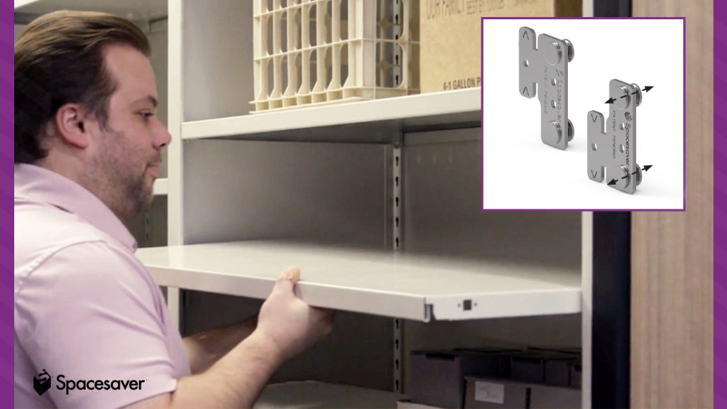 A person installing a metal shelf into a compactor shelving unit. 