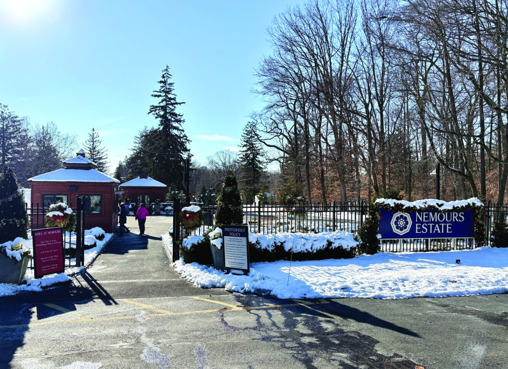 Gates to estate with red brick and snow on the ground