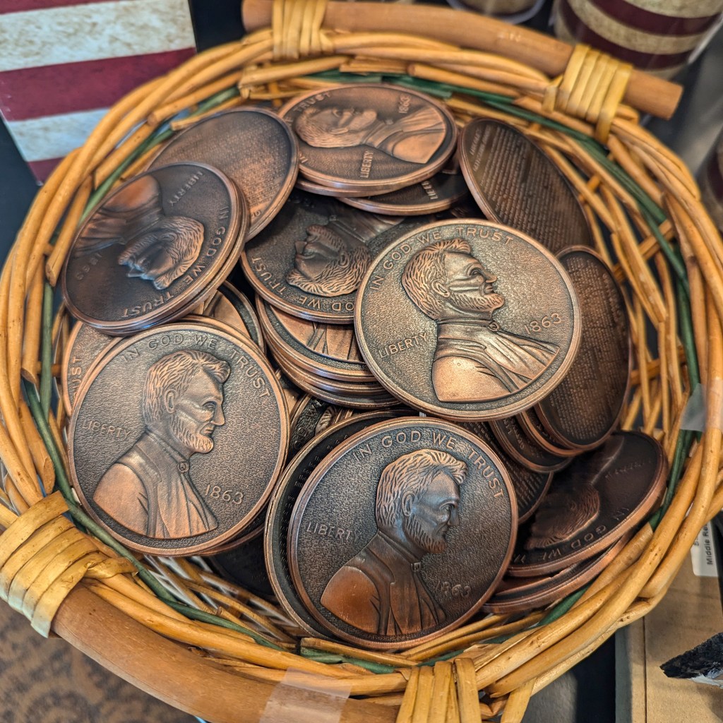 A basket full of imitation oversized pennies