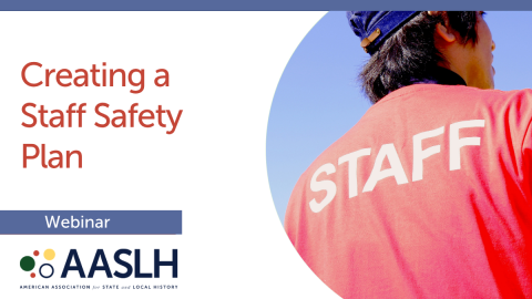 Image of the back of a person wearing a red shirt with Staff written on it.