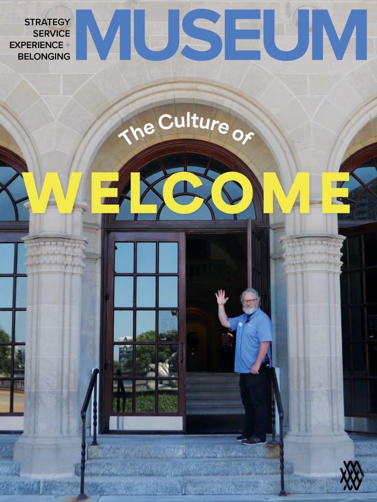 Man standing in front of the entrance to the Chrysler Museum of Art