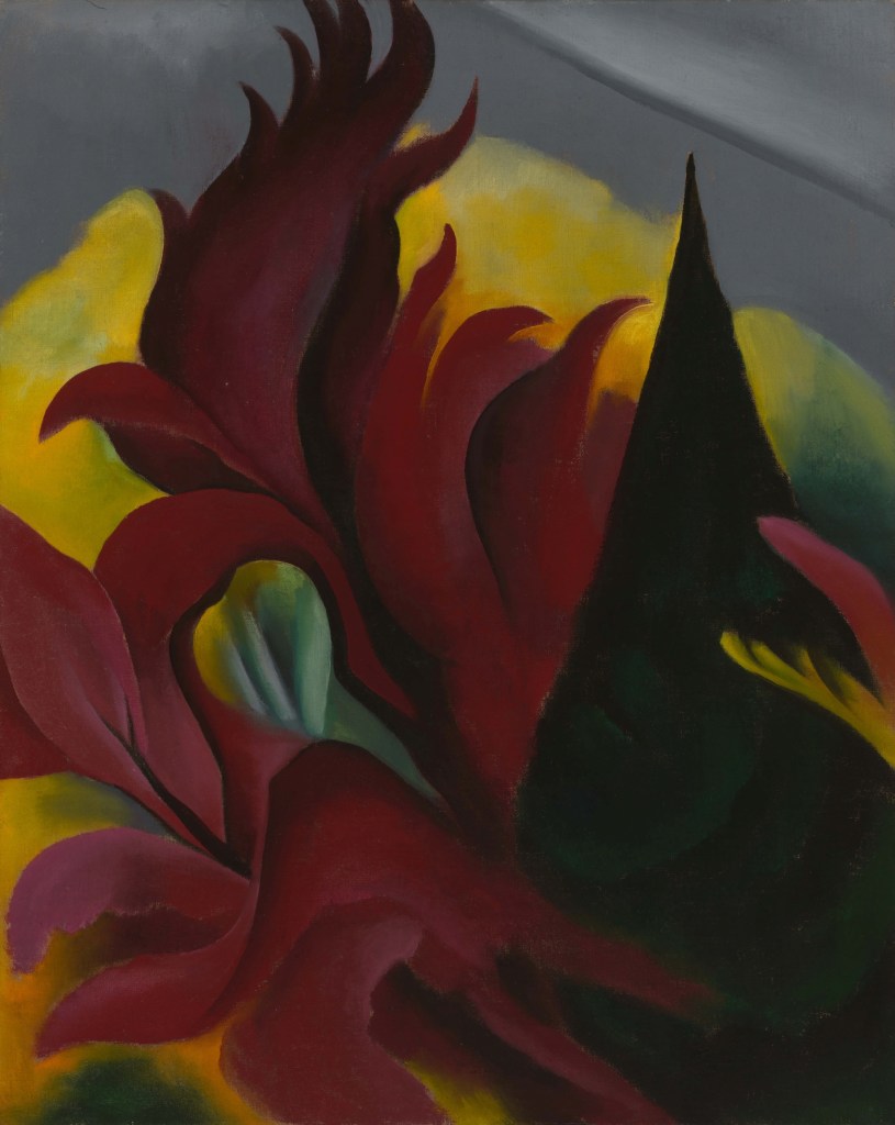 A fiery red flower leads over a yellow background with a large dark green leaf like structure on the right.