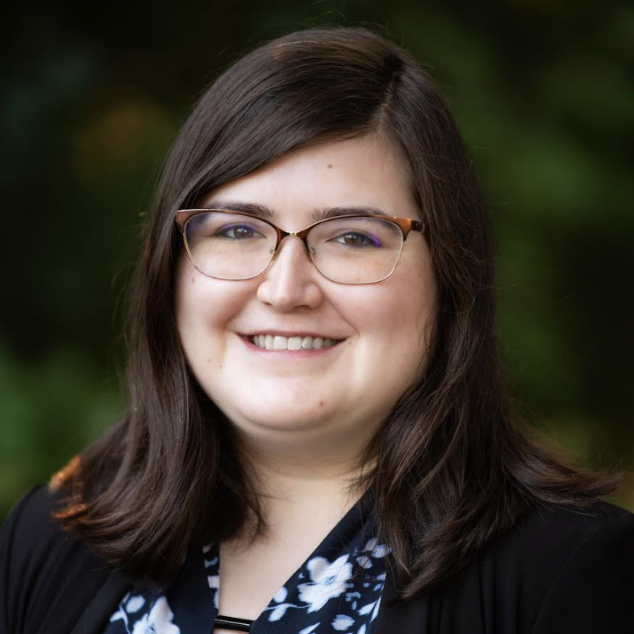 Jessica Meis, a smiling white woman with shoulder length brown hair and glasses.