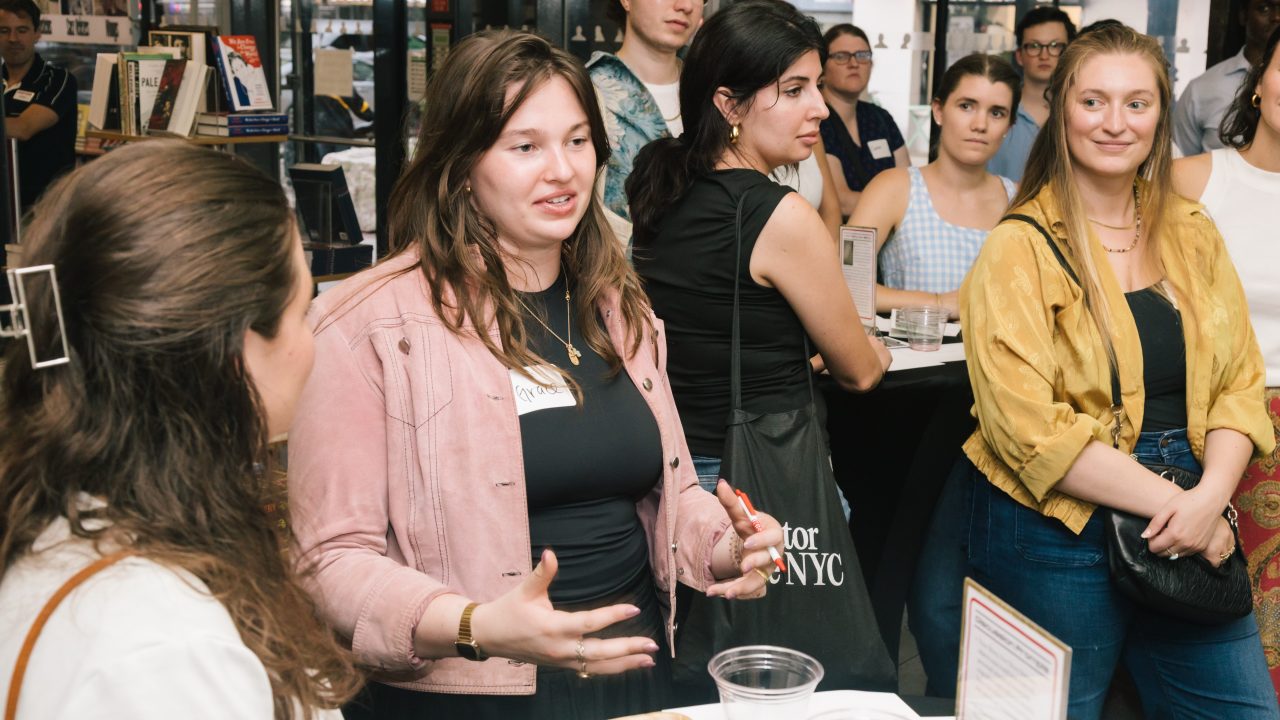 A group of young adults mingling in a museum store space