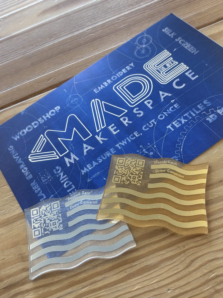Translucent colored tactile markers with raised QR codes are arranged in rows for visitors to hold and scan to access audio interpretation connected to veteran artists’ stories.