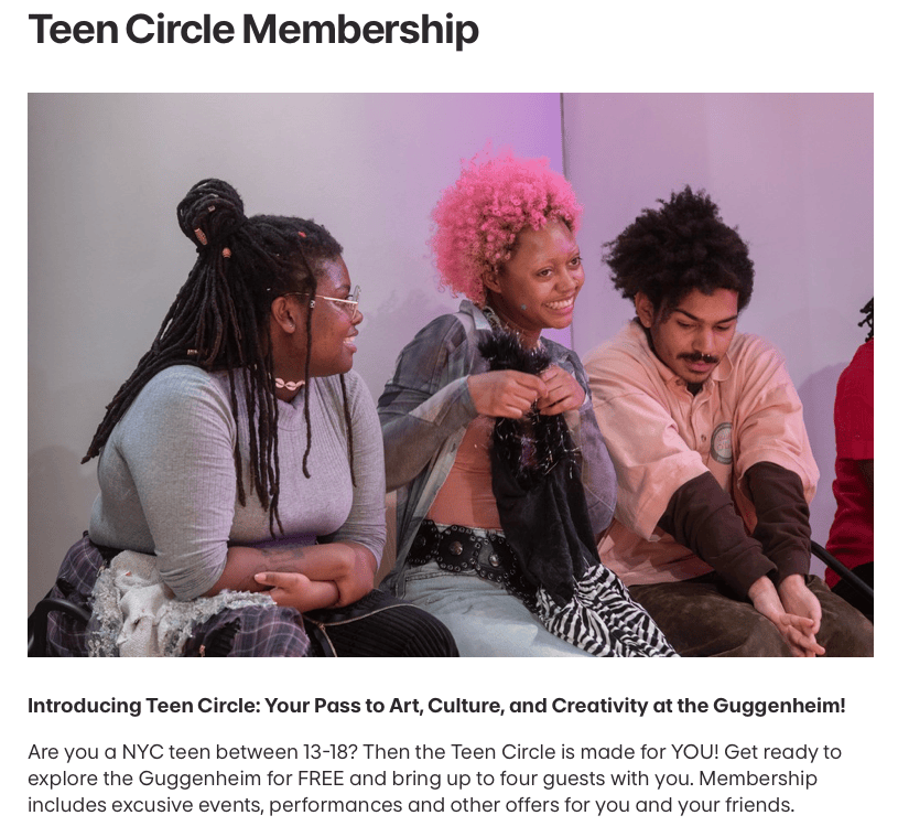 Three teens sit together in a bright room, smiling and interacting while holding a black fabric item during a Guggenheim museum program.