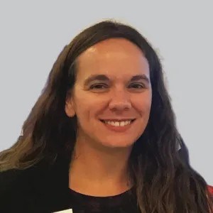 A white woman smiling with long brown hair.